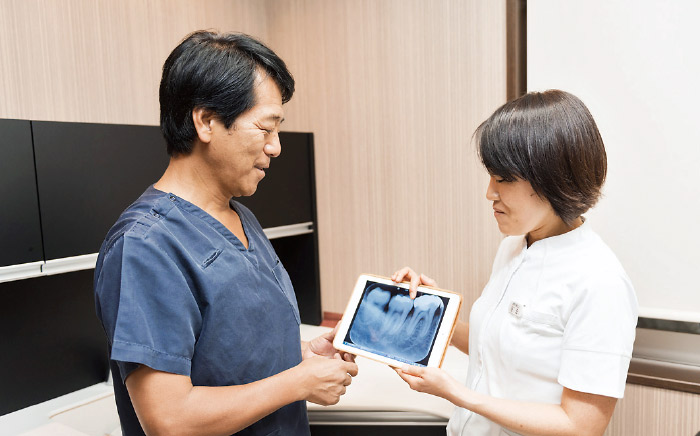 図2 iPadを使用した診療前の打ち合わせ風景。院内をデジタル化したことで、スタッフ間のコミュニケーションもスムーズに。